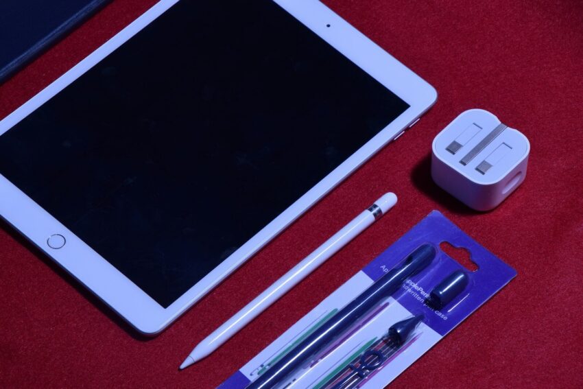 white ipad on red textile